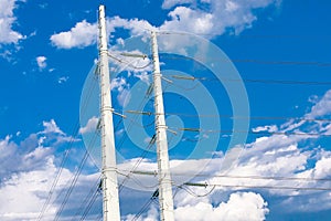 Electricity towers against a blue sky.