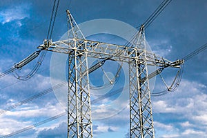 Electricity towers against a blue sky.