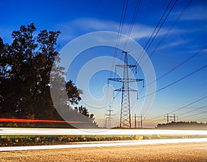 Electricity transmission power lines at sunset High voltage tower.