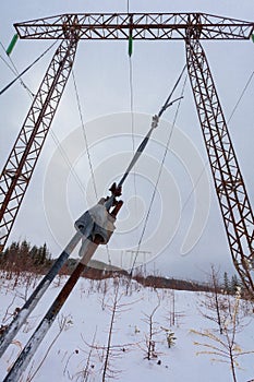 Electricity transmission power lines on winter background High voltage tower.