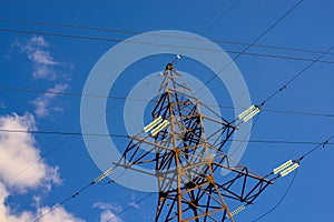 electricity transmission pylon silhouette against blue sky