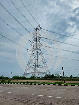 Electricity transmission tower, power lines on the field, nature photography, industrial substation