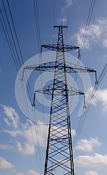 Electricity transmission tower power supply pylon with a blue sky background
