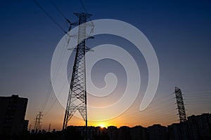 Electricity transmission tower with sunset