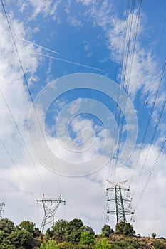 Electricity transmission towers against blue sky background