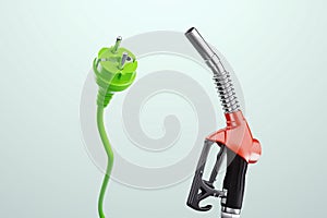 Electricity versus combustible fuel. Gas station nozzle and electrical plug. Technology, car costs, electric car vs gasoline car.