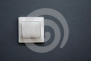 Electricity white light switch on the grey wall