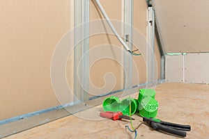 Electricity wire installation into plasterboard wall in attic. Attic renovation