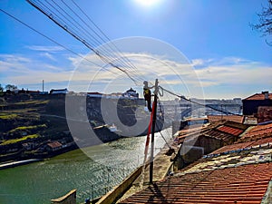 Electricity worker wires Porto cityscape
