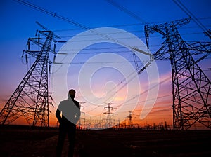 Electricity workers and pylon silhouette