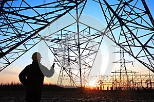 electricity workers and pylon silhouette