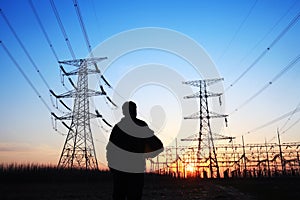 electricity workers and pylon silhouette