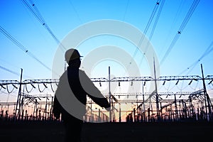 electricity workers and pylon silhouette