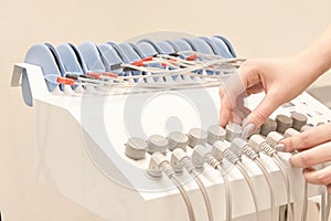 Electro stimulation device. woman hand switch control. safe body anti cellulite. Cosmetology equipment. Electrodes massage machine