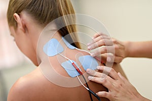 Electro stimulation in physical therapy to a young woman