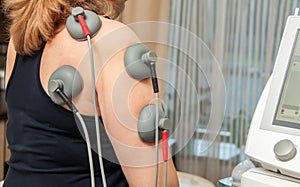 Electro stimulation in physical therapy to a young woman