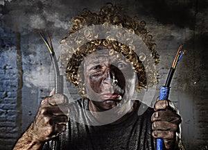 Electrocuted man with cable smoking after domestic accident with dirty burnt face shock electrocuted expression