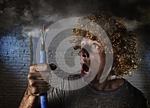 Electrocuted man with cable smoking after domestic accident with dirty burnt face shock electrocuted expression