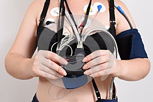 Electrodes Holter monitoring and blood pressure monitor system on the chest of a woman