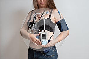 Electrodes Holter monitoring and blood pressure monitor system on the chest of a woman