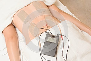 Electrodes of tens device on back muscle