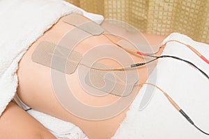 Electrodes of tens device on back muscle