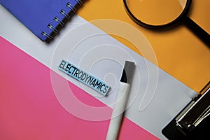 Electrodynamics text on sticky notes with color office desk concept