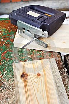 Electrofret saw and wooden board photo