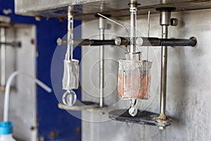 Electrolysis of copper sulfate in lab. It takes place in an electrolytic cell where electrolysis