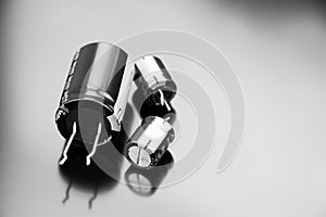 Electrolytic capacitors isolated on a black background. Copy space. Electronic components.