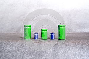 Electrolytic capacitors of various sizes are arranged in a row
