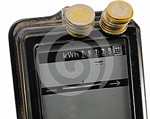 electromechanical electricity meter with the display indicating the kW consumed by the user and euro coins photo