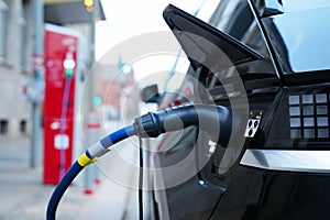 Electromobile charging plug is inserted into vehicle charging socket.