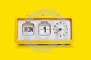 Electronic alarm clock and analog flip calendar. Retro design from 60s 70s home interior. Bright yellow color