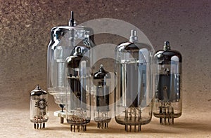 Electronic background with vintage vacuum tubes on kraft paper.