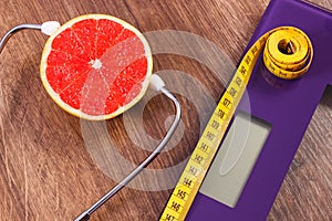 Electronic bathroom scale, centimeter and grapefruit with stethoscope, slimming and healthy lifestyles