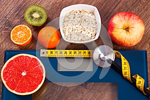 Electronic bathroom scale, centimeter and stethoscope, healthy food, slimming and healthy lifestyles concept