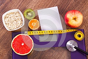 Electronic bathroom scale, centimeter and stethoscope, healthy food, slimming and healthy lifestyles concept