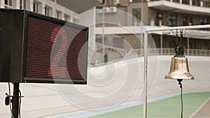 Electronic board with lap numbers on velodrome. Bike race on cycling track. Cyclist racing on velodrome, riding fixed gear bicycle