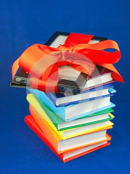 Electronic book reader tied up with red ribbon