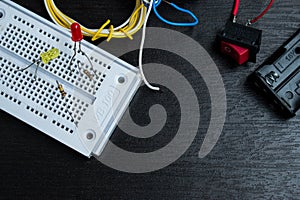 Electronic breadboard on the dask with some cables