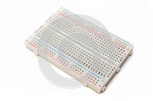 Electronic breadboard isolated on white background. A breadboard is used for solderless electronic prototyping