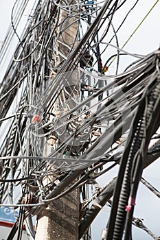 Electronic and cable line, chaotic wire on pole with sky background