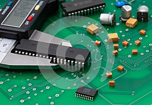 Electronic caliper measure IC and electronic part on green pcb