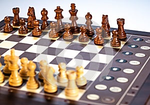 Electronic chess board on a plain white background with focus on the black pieces