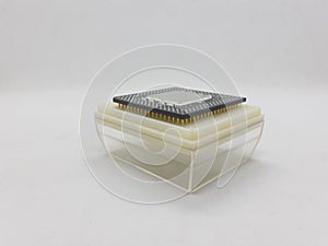 An electronic chip and it`s container in white isolation background