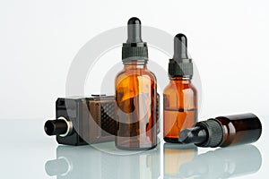 Electronic cigarette with smoking liquid bottle on white background