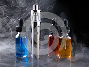 Electronic cigarette and vape liquids within vapor on black background