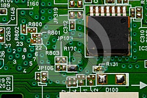 Electronic circuit close-up microchip on a green microcircuit with elements of transistors and strapping