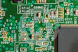 Electronic circuit close-up microchip on a green microcircuit with elements of transistors and strapping